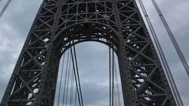 point of view of car driving over george washington bridge between fort lee new jersey and manhattan york heights (sunset night time cloudy suspension bridge)
