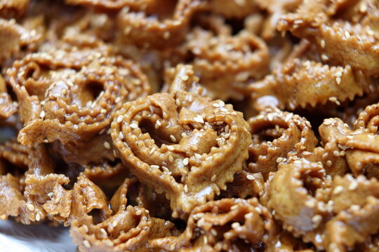 Macro close-up of traditional Moroccan Chebakia pastries coated in honey and sesame seeds
