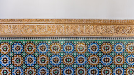 Zellige mosaic shows colorful geometric patterns and designs in Madrasa Ben Youssef. The work...
