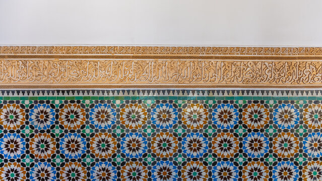 Zellige mosaic shows colorful geometric patterns and designs in Madrasa Ben Youssef. The work showcases traditional Moroccan art. Visitors admire this unique piece of history.
