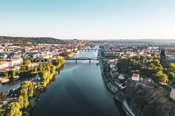 Fototapeta premium The Vltava River flowing through Prague. The view includes the Vysehrad and Prague Castle. The time is early morning with a clear sky.