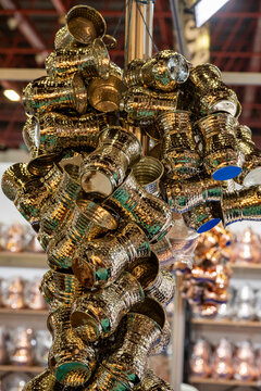 Metal coffee cezve with decorative oriental pattern on the shop window. Household items copper items for sale. Cupric coffe epots at the bazaar in Antalya Turkey. Turkish coffee pots. Metal coffee cez