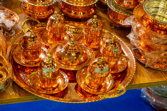 Metal coffee cezve with decorative oriental pattern on the shop window. Household items copper items for sale. Cupric coffe epots at the bazaar in Antalya Turkey. Turkish coffee pots. Metal coffee cez