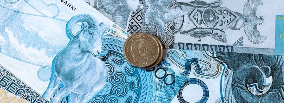 Kazakhstani tenge money banknotes and coins on table. Kazakhstan cash bills of KZT currency