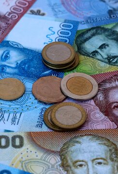 Chilean peso money banknotes and coins on table. Chile cash bills of CLP currency