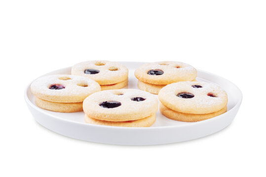 Linzer cookies in the form of scary monster for Halloween holidays in a plate on a white isolated background