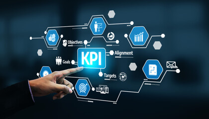A business professional interacts with a digital display of KPI graphics, showcasing essential elements of objectives, targets, and analytics for performance evaluation. Tessel © InfiniteFlow