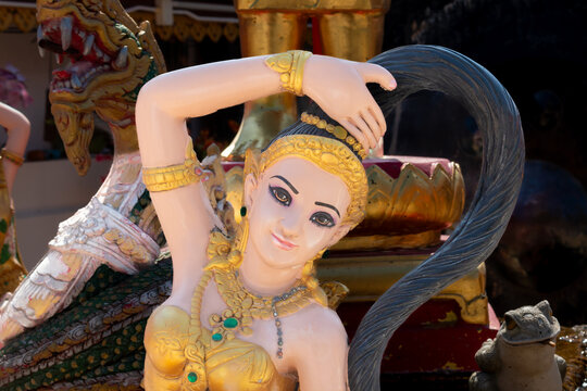 Phra Mae Thorani (Earth Goddess) statue at Wat Phra That Doi Kham, Chiang Mai, Thailand