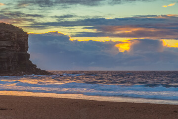 Fototapeta premium Seaside Sunrise with a hint of rain in the clouds