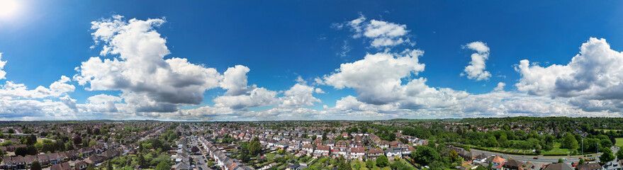 Fototapeta premium High Angle Panoramic View of Residential Homes at Luton City During Hot Weather and Sunny Day. Urban Drone Flight Above Urban City Streets of British City and Town of England Great Britain.