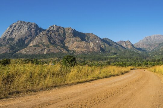 Dusty Road leading to the granite peaks of Mount Mulanje, Malawi