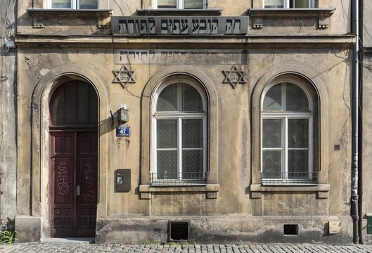 Remains of Torah inscription and stars of David on house facade in Kazimierz, Krakow, Poland