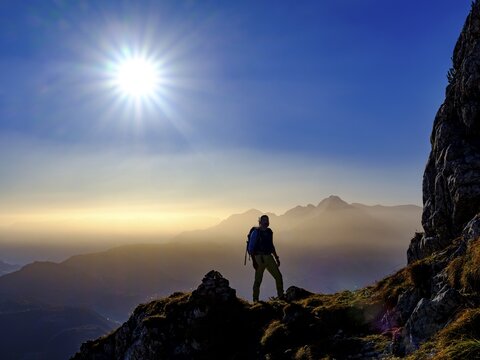 Silhouette of a mountaineer on an exposed path in the morning sun, in the background Hoher G&ouml;ll, Grubenpfad, Untersberg, Berchtesgadener Alpen, Marktschellenberg, Berchtesgadener Land, Upper Bavaria, Bavaria, Germany