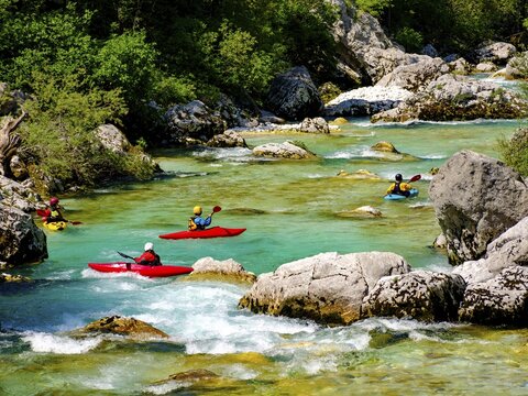 Kayakers on the emerald green Soca River, Soca Valley, Triglav National Park, Bovec, Slovenia