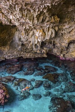 Tourist snorkeling in the Avaiki rock tide pools, South Pacific, Niue