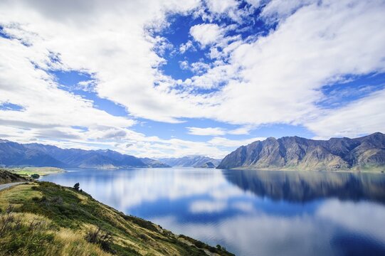 Cloudy sky with water reflections in Lake Hawea, Haast Pass, South Island, New Zealand