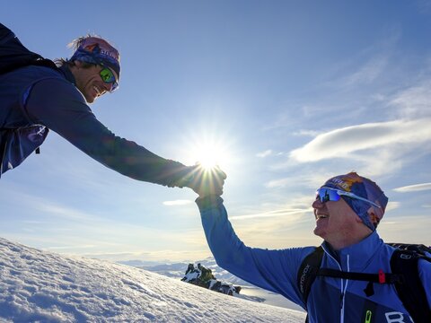 Berg Heil, mountain guide congratulates his guest on the ascent of Husafjellet, Senja Island, Troms, Norway