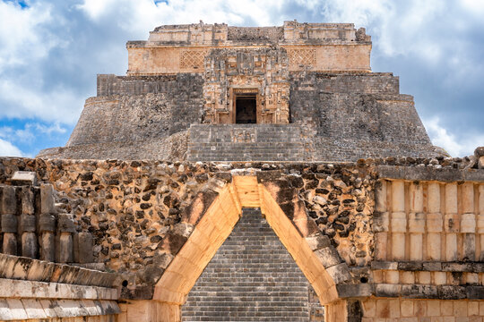 Detailed view of stone structures in Uxmal archaeological site Yucatan Mexico, showcasing ancient Mayan architecture, textures open spaces, surrounded by grass historic buildings under bright daylight