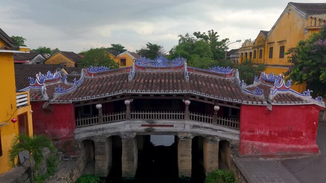 Aerial view of Chua Cau or Japanese Covered ancient Bridge and River in Old city of Hoi An, Vietnam. One of the most travel popular touristic destinations, UNESCO world heritage 