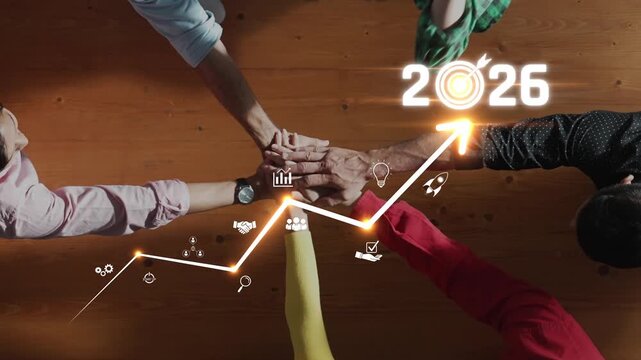 This image captures the essence of business growth toward 2026, featuring hand gestures that symbolize success and innovation against a warm wooden backdrop. Raster