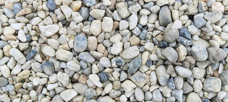 Close-up of smooth river pebbles with a soft watercolor-like bokeh background. Elegant, artistic presentation designed for subtle web banners and creative multimedia layouts