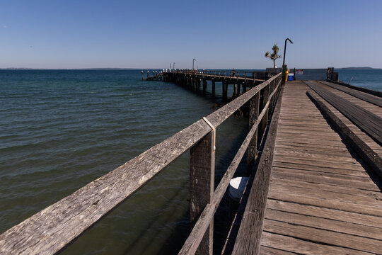 weathered timber jetty on a calm and sunny day