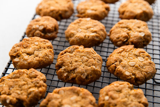 close up of ANZAC biscuits cooling down on a rack