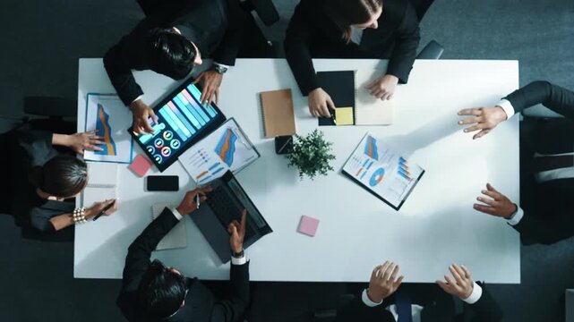 Top down aerial view of smart businessman use vr headset to enter virtual world at meeting while diverse business people send financial information and data analysis graph in database. Directorate.