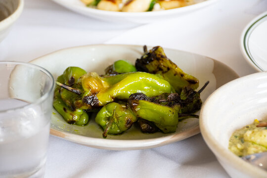 Plate of green peppers on a dining table