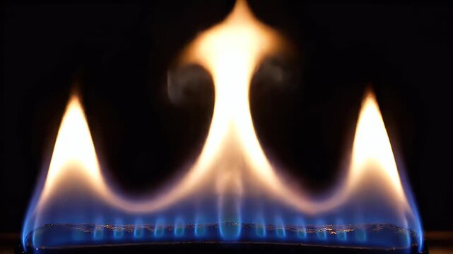 Close-up view of bright blue and yellow flames against a dark background