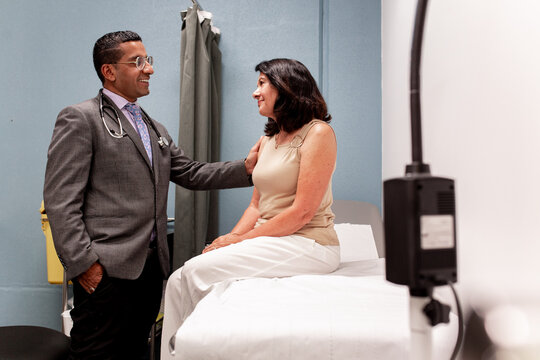 Doctor reassuring patient in examination room