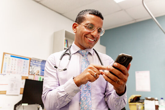 Doctor using smartphone in medical office