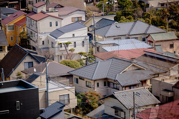 Fototapeta premium Historic temple buildings overlook the city from the elevated grounds of Hasedera Temple in Kamakura, Japan.