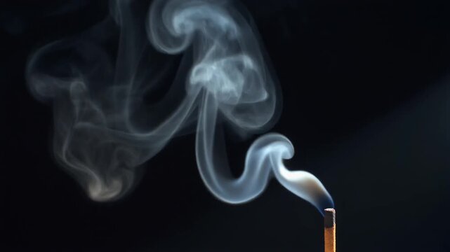 Graceful Smoke Rising from Burning Incense Stick in Dark Studio Environment, Close-up