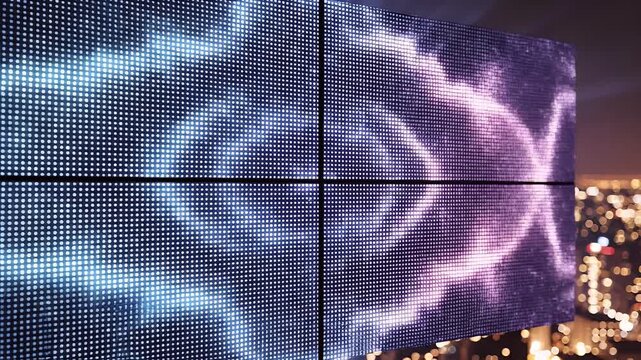 A massive digital billboard illuminates a city skyline at night with dazzling blue patterns