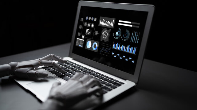 A futuristic robot hand interacts with a laptop displaying complex data visualizations in a dark setting, symbolizing advanced technology and data analysis. Gantry
