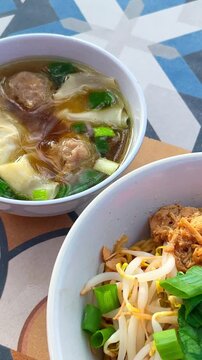 Chicken noodle with meatball and dumpling.