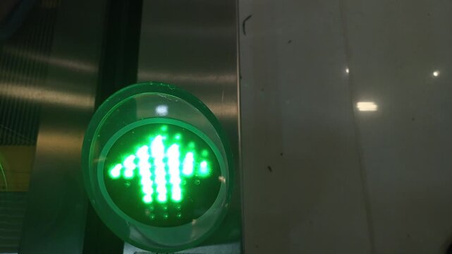The green light arrow sign turned on for moving up close up in elevator 