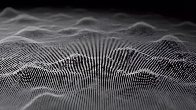 A close-up shot reveals a textured, dark gray surface with a repeating pattern of small, evenly spaced perforations, creating a modern and industrial aesthetic.