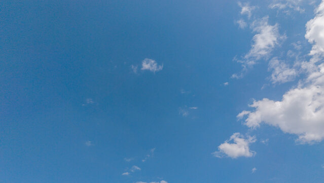 Wide blue sky with scattered white clouds on a clear sunny tropical day in West Sumatra, Indonesia