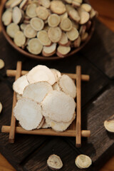 Fototapeta premium Chinese Herbs Dahurica Root Slices Traditional Medicine Seasoning Ingredients