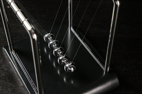 Newton's Cradle Physics Pendulum Demonstrating Motion and Energy Transfer with Chrome Steel Balls
