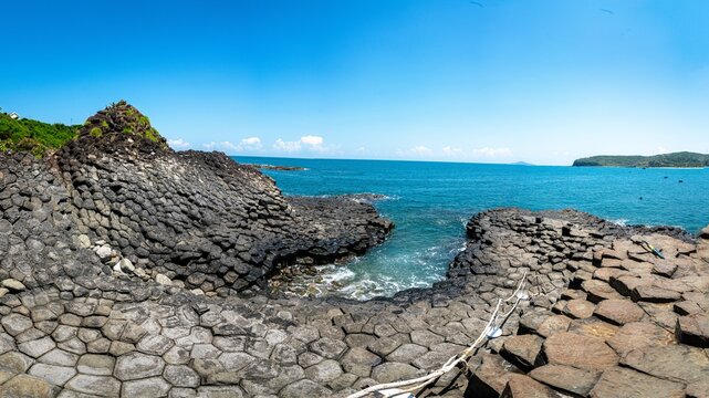 Ganh Da Dia (Sea Cliff of Stone Plates), the famous basalt rock formation in Tuy An District, Phu Yen Province, Vietnam. Ancient hexagonal volcanic columns create a dramatic natural rock pavement alon