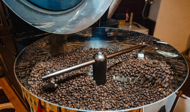 Selected coffee beans are roasted in production. Close up of coffee roasting process