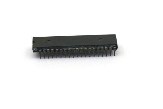 A blurry microcontroller on a white background. An archaic concept of technological advancement.