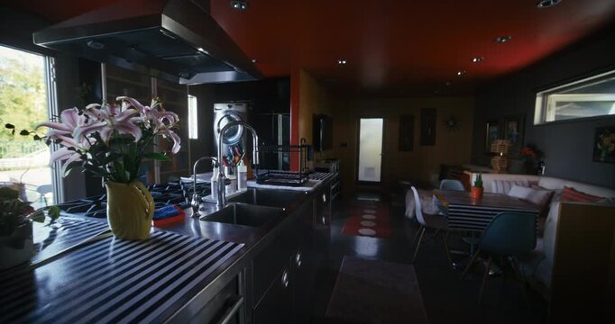 Slow motion steady cam through luxury kitchen covered in shadow