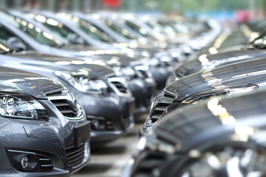 Rows of Gray Sedans Lined Up in a Car Dealership Lot Ready for Sale