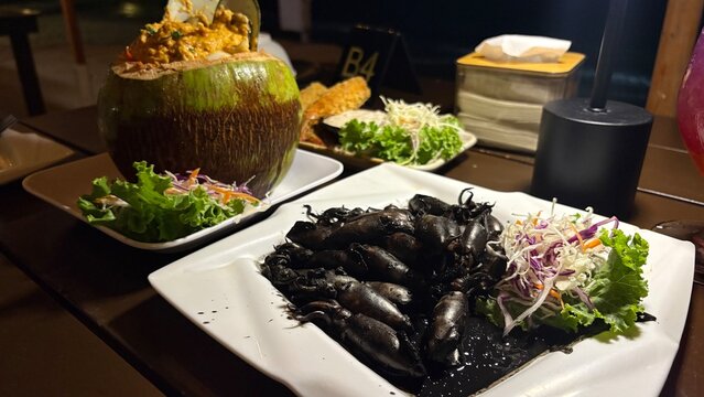 Hor Mok in Young Coconut  and Stir-Fried Squid with Black Ink , thai food image.