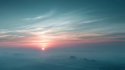 Fototapeta premium Misty Horizon Sunrise Over Foggy Landscape with Soft Pastel Sky and Distant Hills