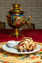 Fototapeta premium Traditional Russian Pancakes Served With Samovar On Blur Background